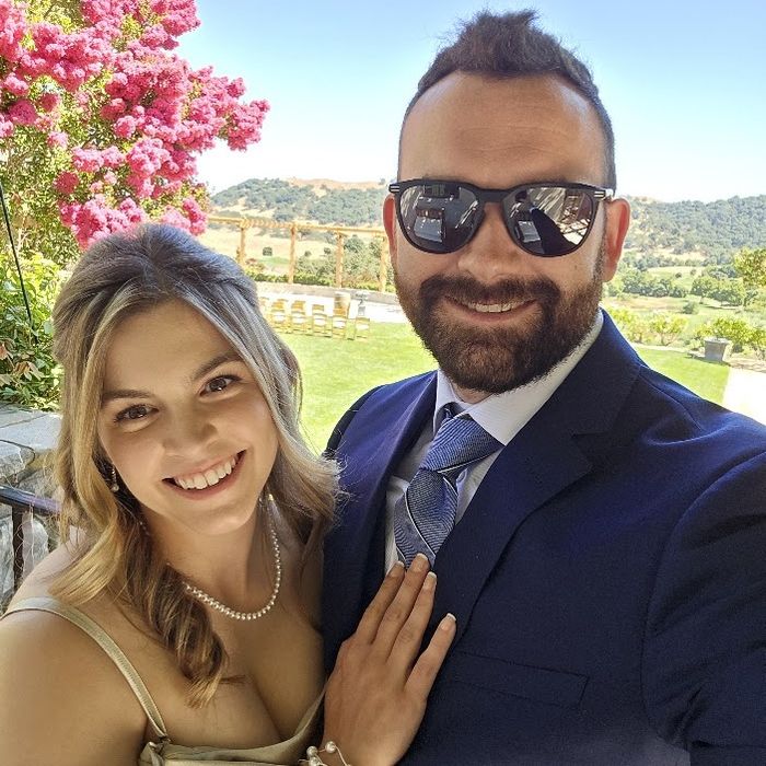 Steph and her husband smiling together at an outdoor wedding